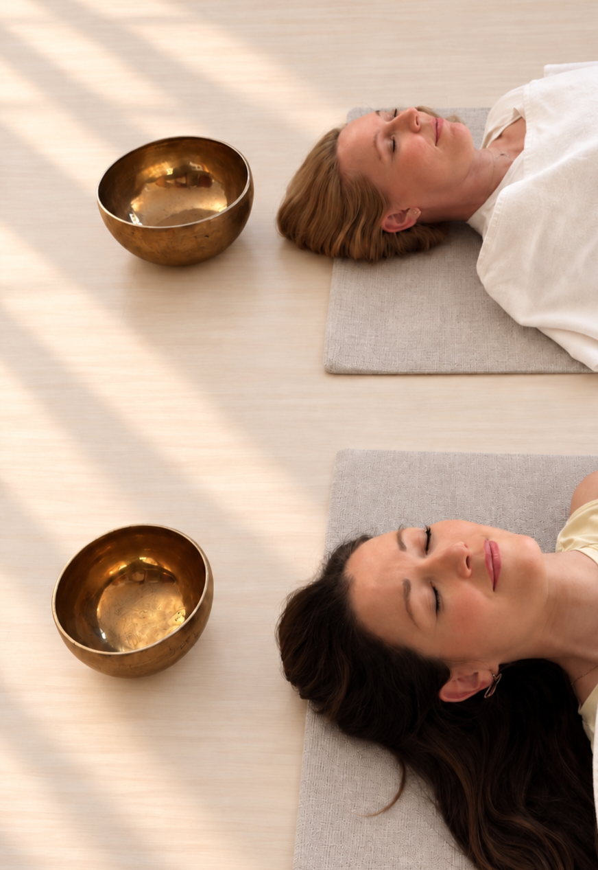 Two people resting during a Tibetan bowl sound therapy session